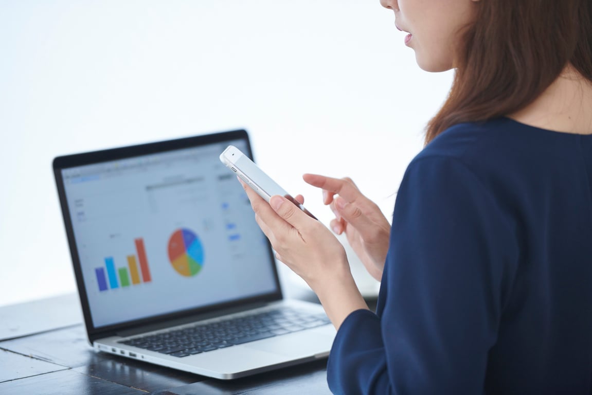 Analyst reviewing multiple unaligned data reports coming from different sources, highlighting the confusion and inconsistency caused by ungoverned ad hoc reporting. i-radius