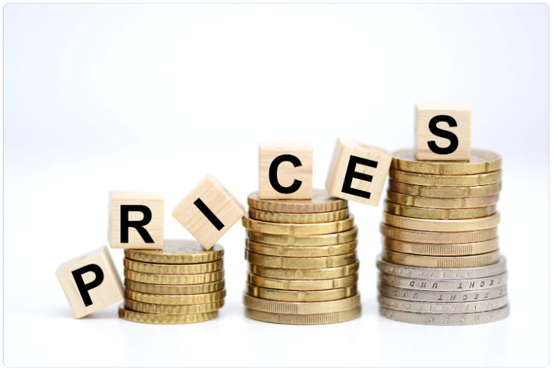 Stacked coins with letter blocks spelling “PRICES,” symbolizing rising and variable analytics costs and the need to manage BigQuery on-demand and flat-rate pricing based on workload patterns. i-radius